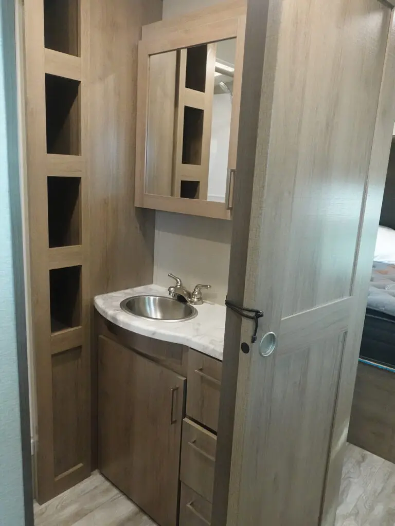 a small bathroom with a sink and mirror