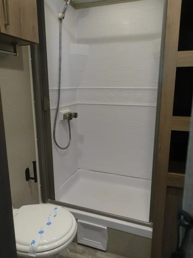 A bathroom with a toilet and shower