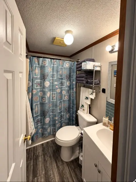 A standard hotel bathroom with a toilet, sink, and shower